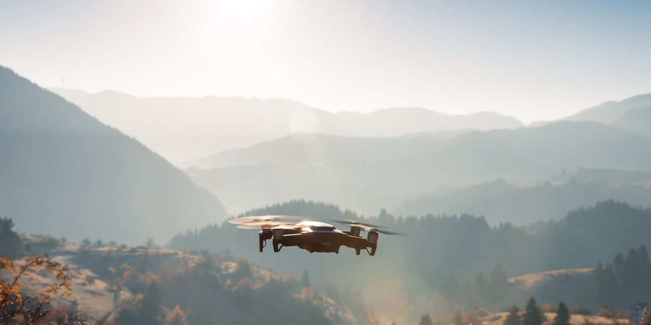 drone hovering taking picture of sunrise in mountain.-min